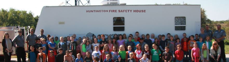 Students in front of a mobile safety unit that teaches fire safety and prevention