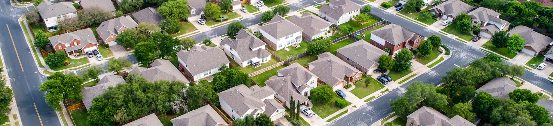 Stock imagery of homes in a neighborhood.