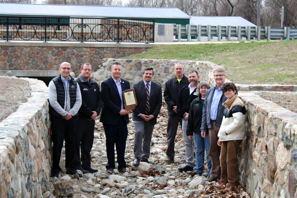 A group of people posing at an award presentation
