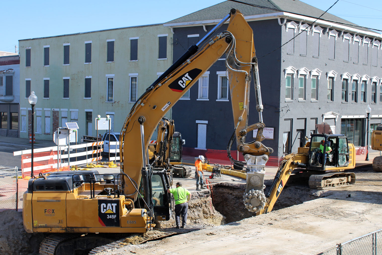 A photo of heavy construction equipment and a deep work trench at the Market and Cherry intersection in downtown Huntington, Indiana.