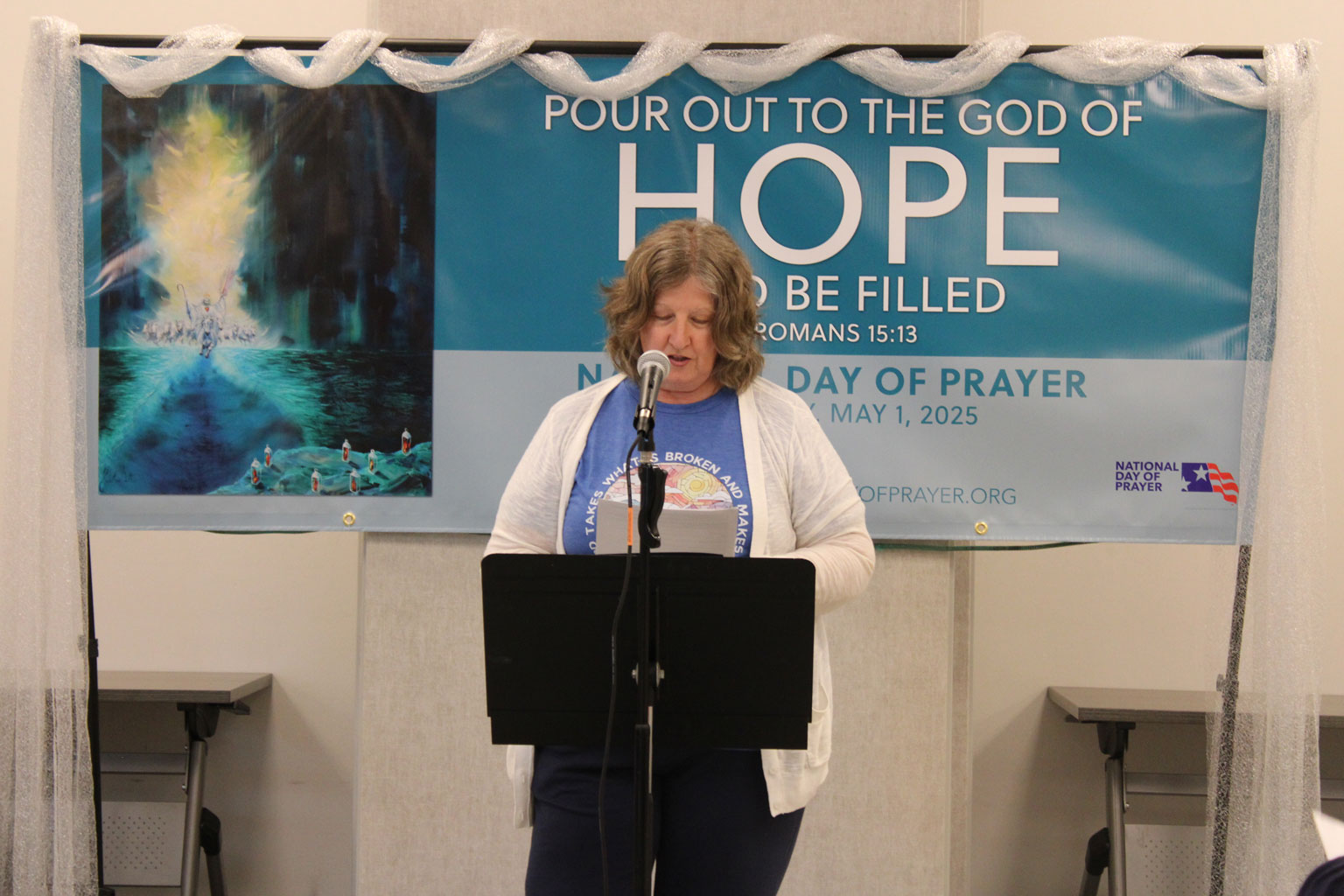 A woman speaks at a podium on National Day of Prayer