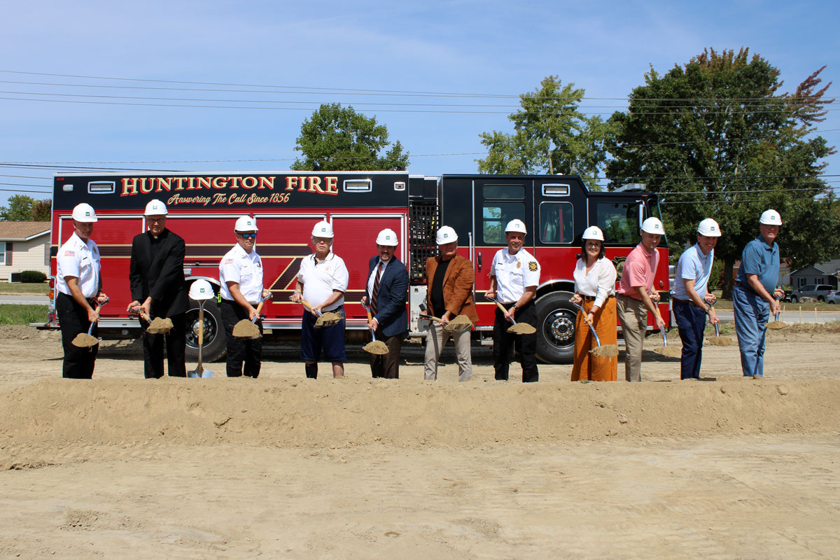 Local officials stand in front of a firetruck during the groundbreaking ceremony for the new Flaxmill Road fire station.